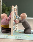 Babygym som er en morsom og stimulerende lekeplass til hjemmet . Babygym som også kan brukes som aktivitetsstativ og som hjelper banyen opp og stå